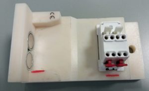 Assembly-line tool designed to hold switches during laser marking operations. 3D printed in ASA material